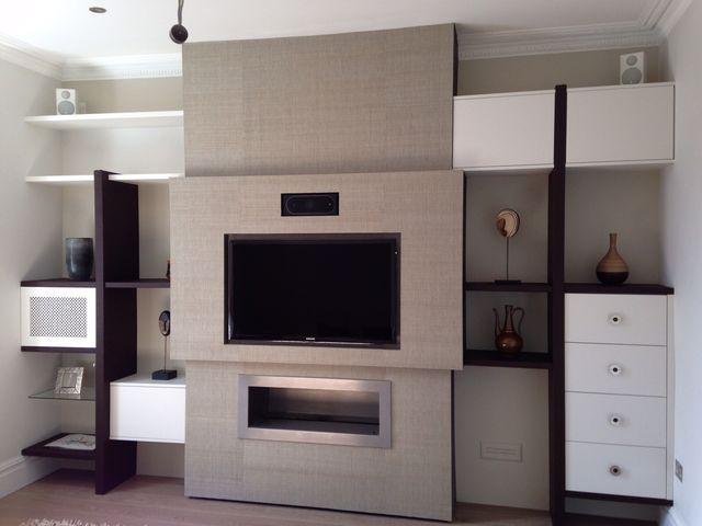 Fitted media wall with shelving and drawers