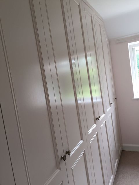 White fitted wardrobes in a bedroom